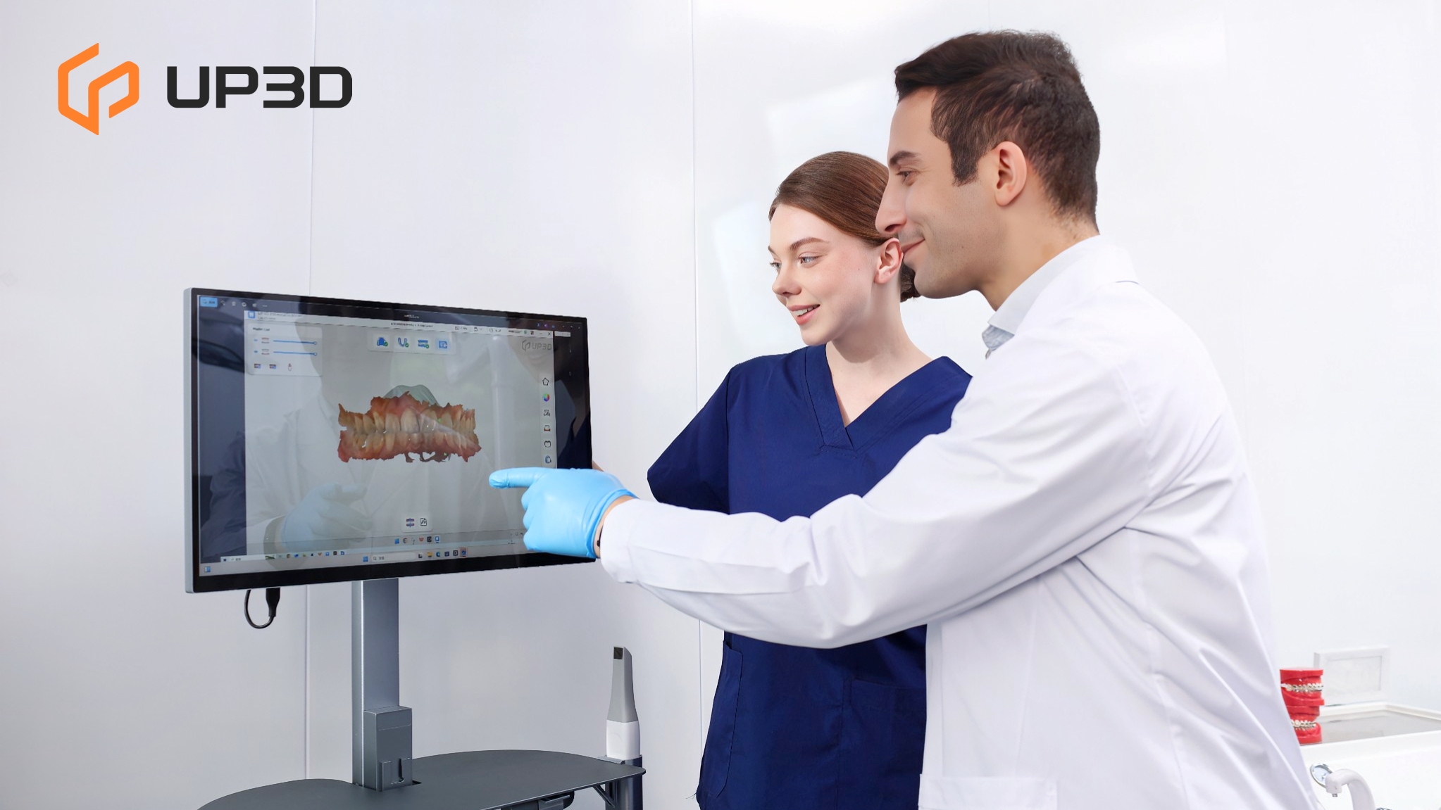Dentists reviewing 3D scan results on screen from UP3D UP610 intraoral scanner, visualizing precise dental models in digital workflow.