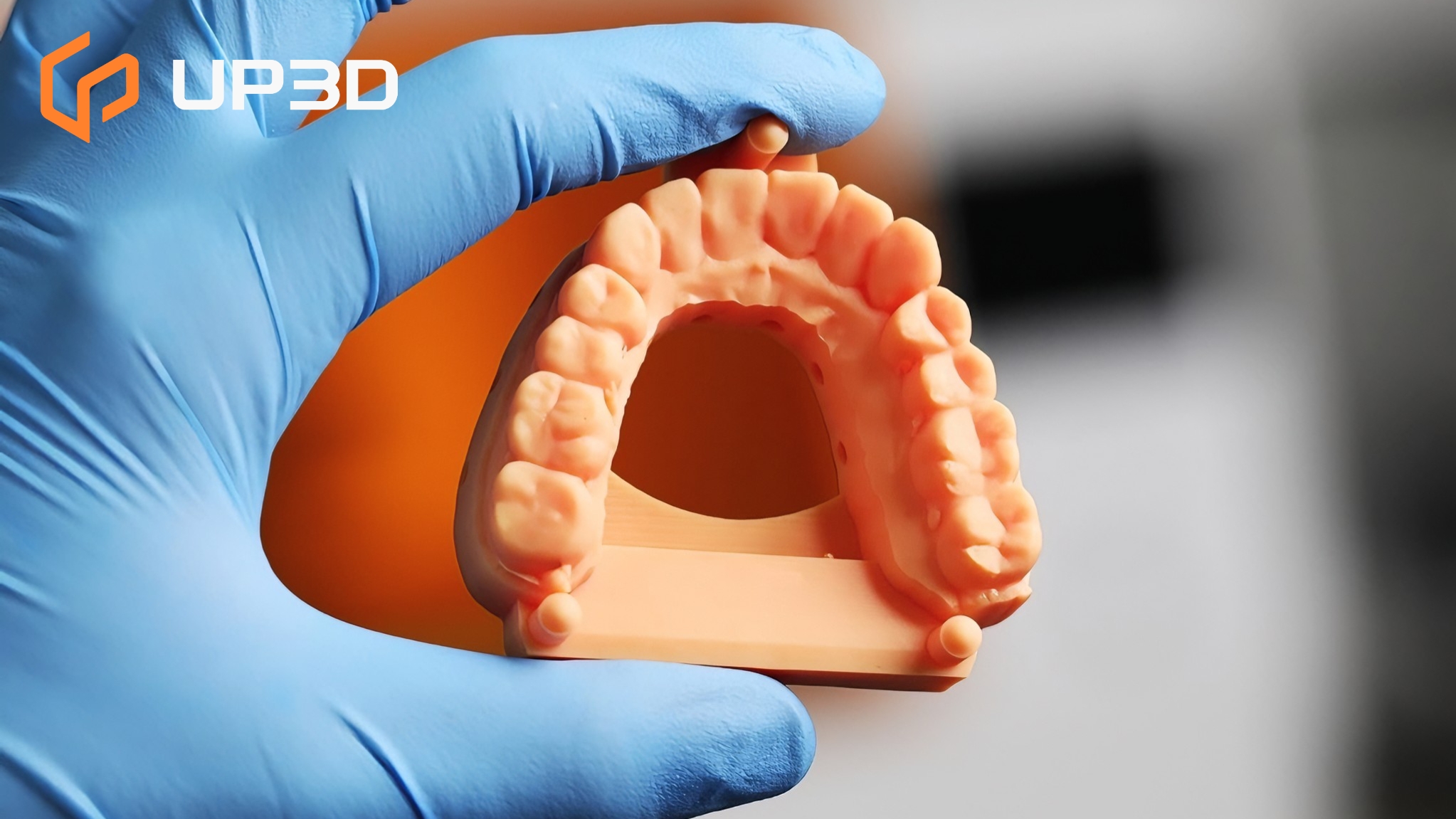 3D printed dental model held by gloved hand, showcasing detailed teeth anatomy