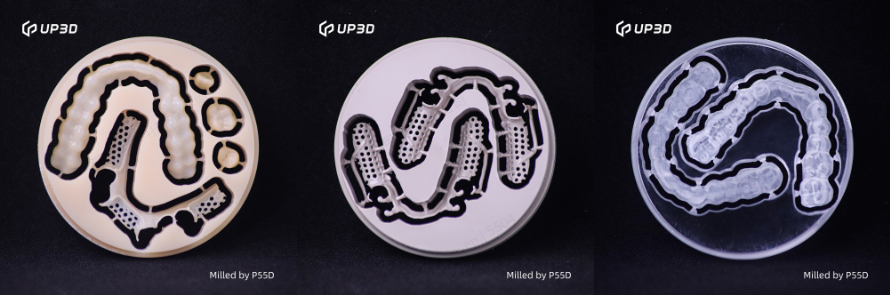 Resin discs milled by UP3D P55D dental milling machine showing PMMA and PEEK restorations with smooth finish