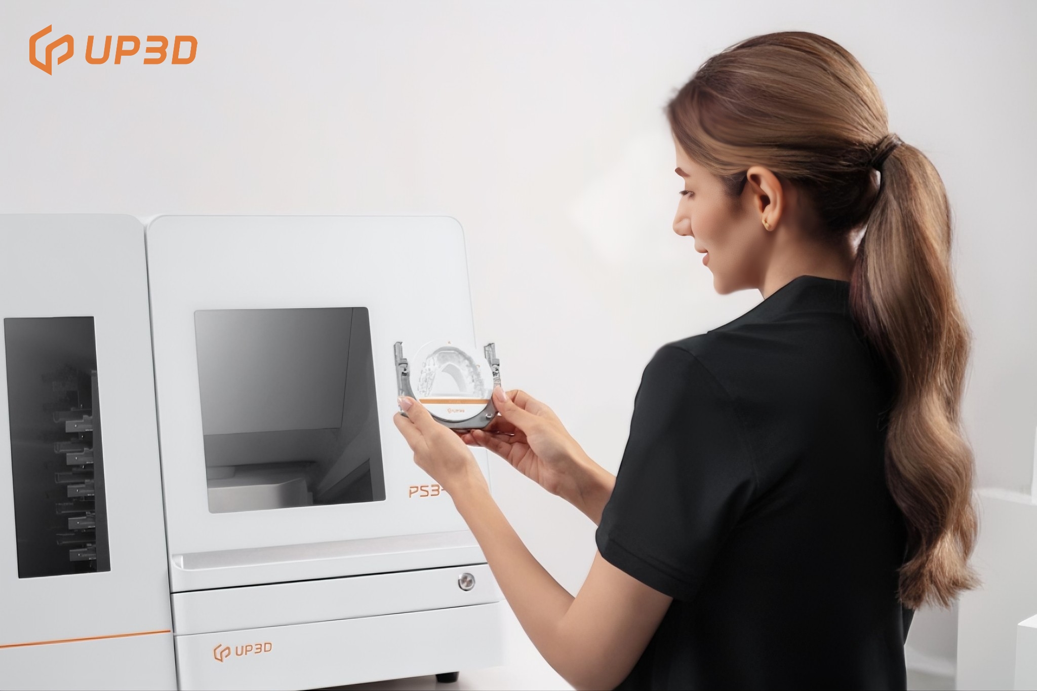 Technician loading dental disc into UP3D P53DC milling machine with auto disc changer for unattended night milling