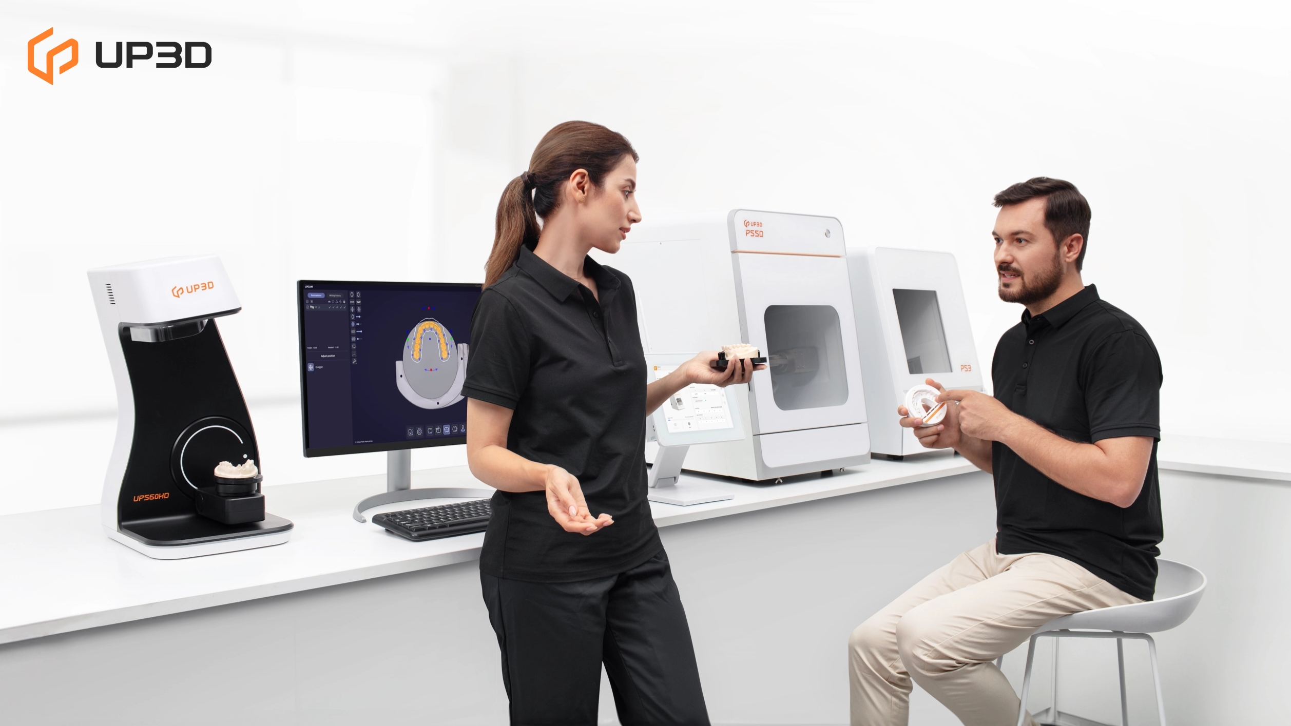 Dental technicians discussing digital nesting and milling workflow using UP3D lab equipment, showing scanners, software, and milling machines in a modern dental lab.