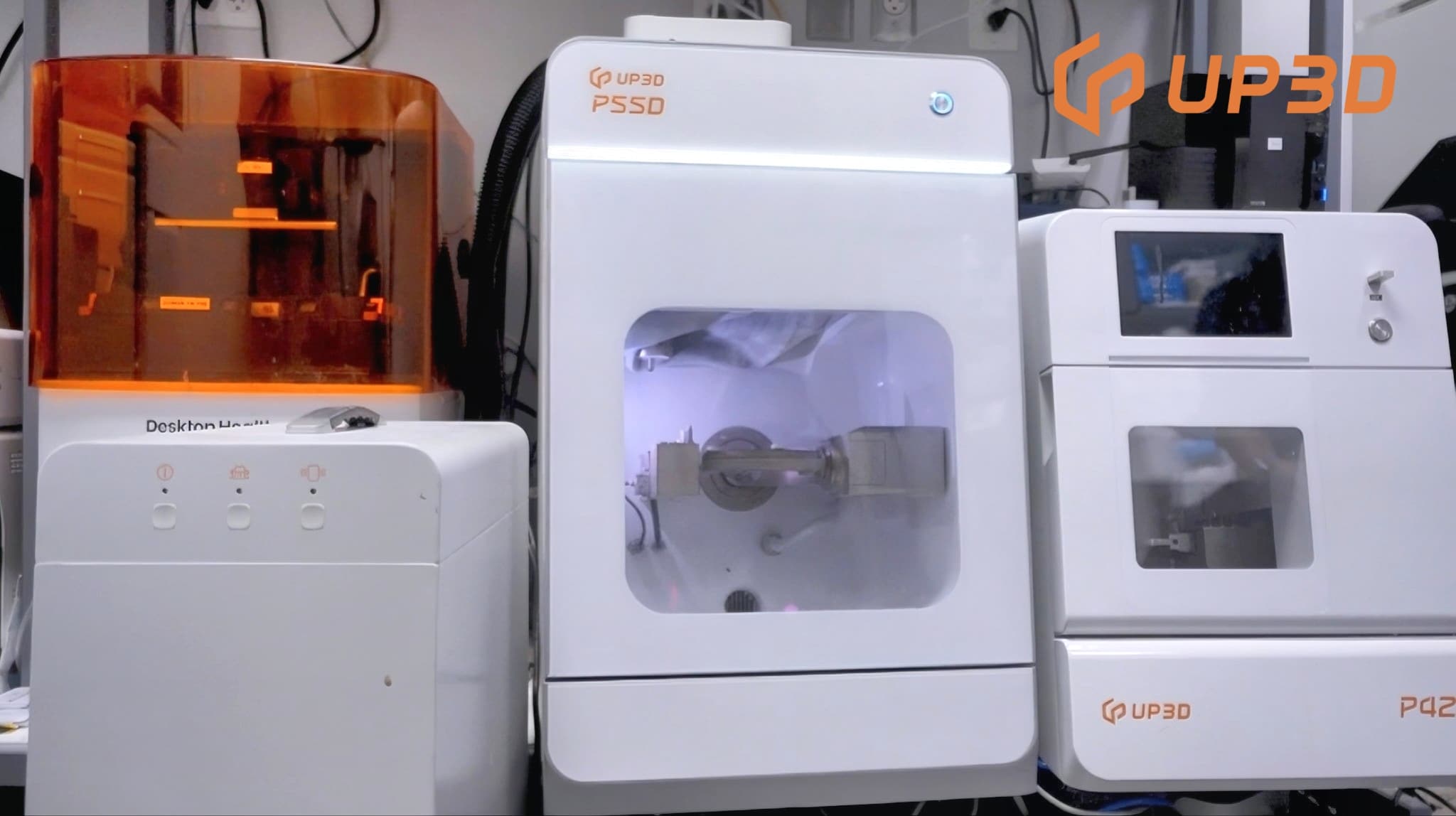 UP3D P55D and P42 dental milling machines installed in a dental lab, demonstrating compact design and professional setup.